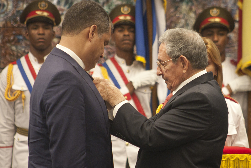 President Raul Castro decorating Rafael Correa.