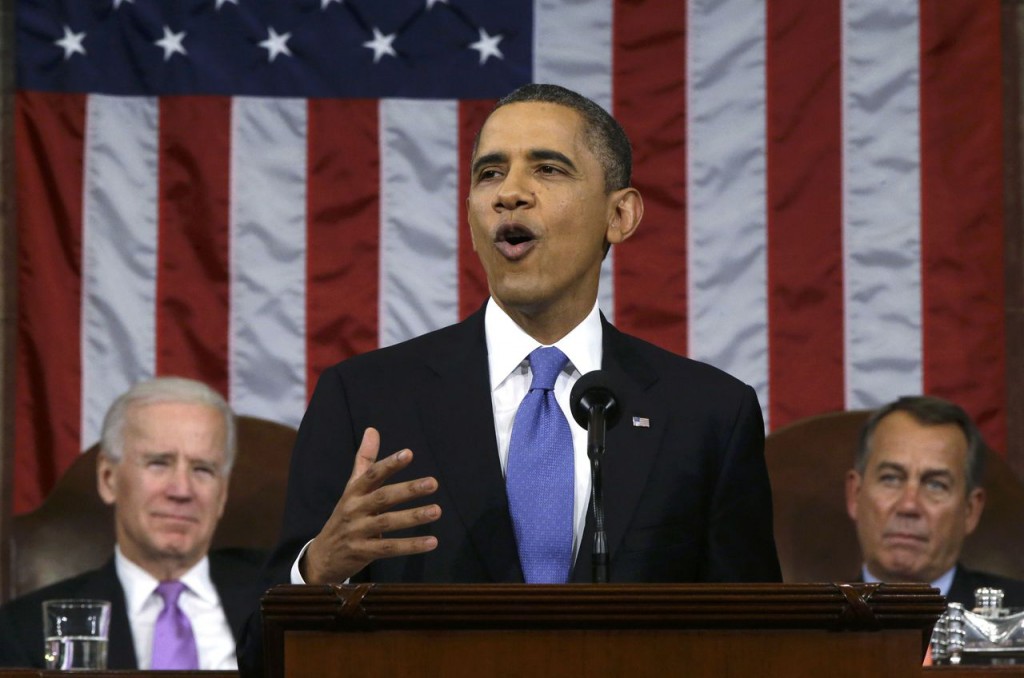 U.S. President Obama delivers his State of the Union speech between Vice President Biden and House Speaker Boehner on Capitol Hill in Washington