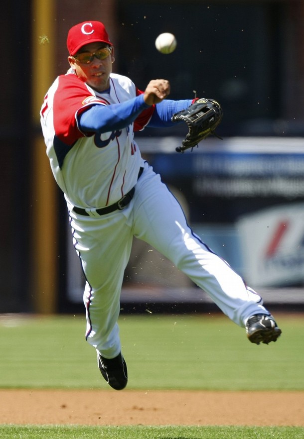 Team Cuba third baseman Michel Enriquez throws out Team Japan's Shuichi Murata in the first inning during Round 2 of the World Baseball Classic in San Diego, California March 15, 2009. REUTERS/Mike Blake (UNITED STATES SPORT BASEBALL)
