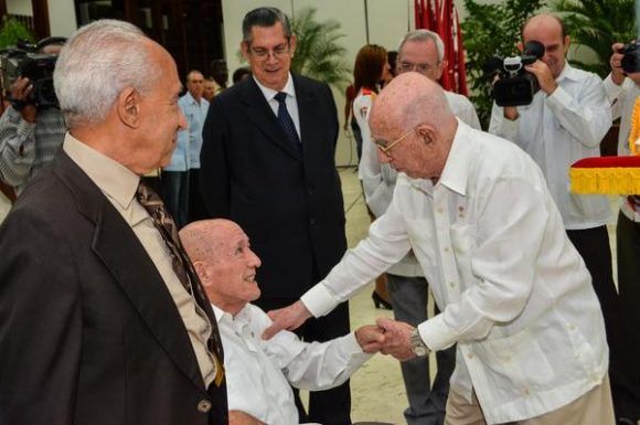 José Ramón Machado Ventura (D), Segundo Secretario del Comité Central del Partido Comunista de Cuba (CC PCC), hace entrega del título de Héroe del Trabajo de la República de Cuba a Roberto Verrier, profesor de la Universidad Camilo Cienfuegos, de Matanzas, en ceremonia efectuada en el Salón de Protocolo de Cubanacán, en La Habana, el 29 de abril de 2017. Foto: ACN / Marcelino Vázquez Hernández