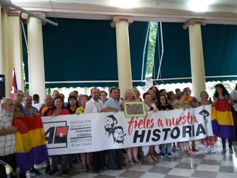 Fernando González, Yolanda García (al centro) y el resto de los presentes sosteniendo una pancarta que rememora el aniversario de la Asociación.