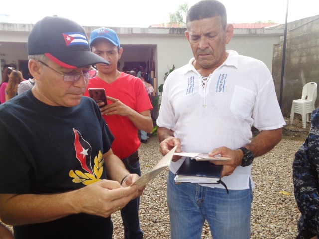 Julio César García Rodríguez, jefe de la Oficina de Atención a las Misiones Sociales de Cuba en Venezuela, (primer plano a la izquierda) departe con Rayo.