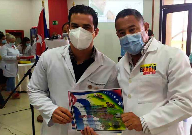 El doctor Misael Arias Reyes (a la derecha) entrega estímulo a miembros del Contingente Henry Reeve.