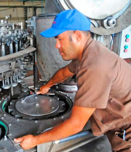 Keilen Correa con sus innovaciones mantiene la funcionalidad tecnológica de la obsoleta máquina llenadora-tapadora de la fábrica de cervezas de Guantánamo. Foto: Mayliovys del Toro Terrero